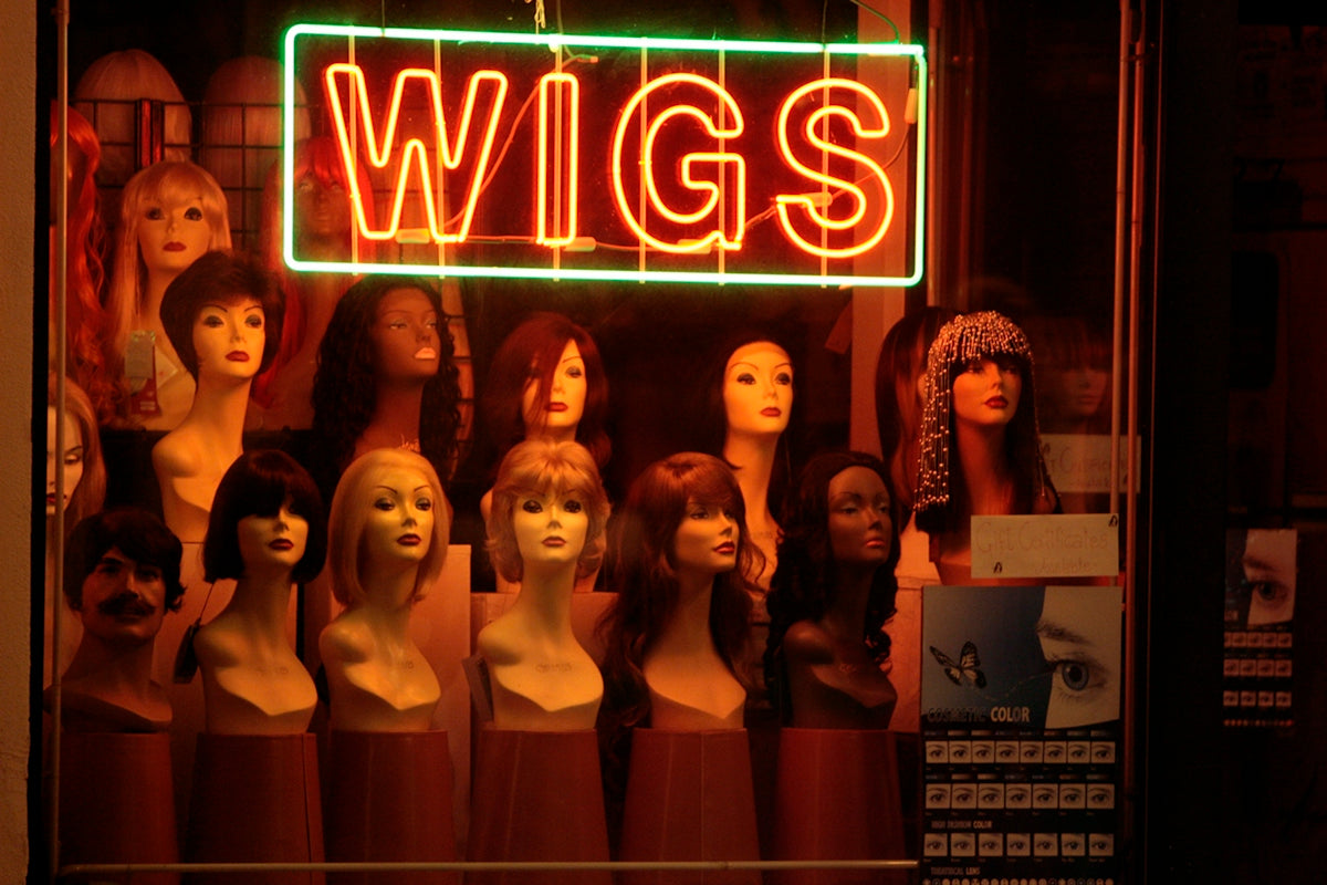a display of wigs in a store window