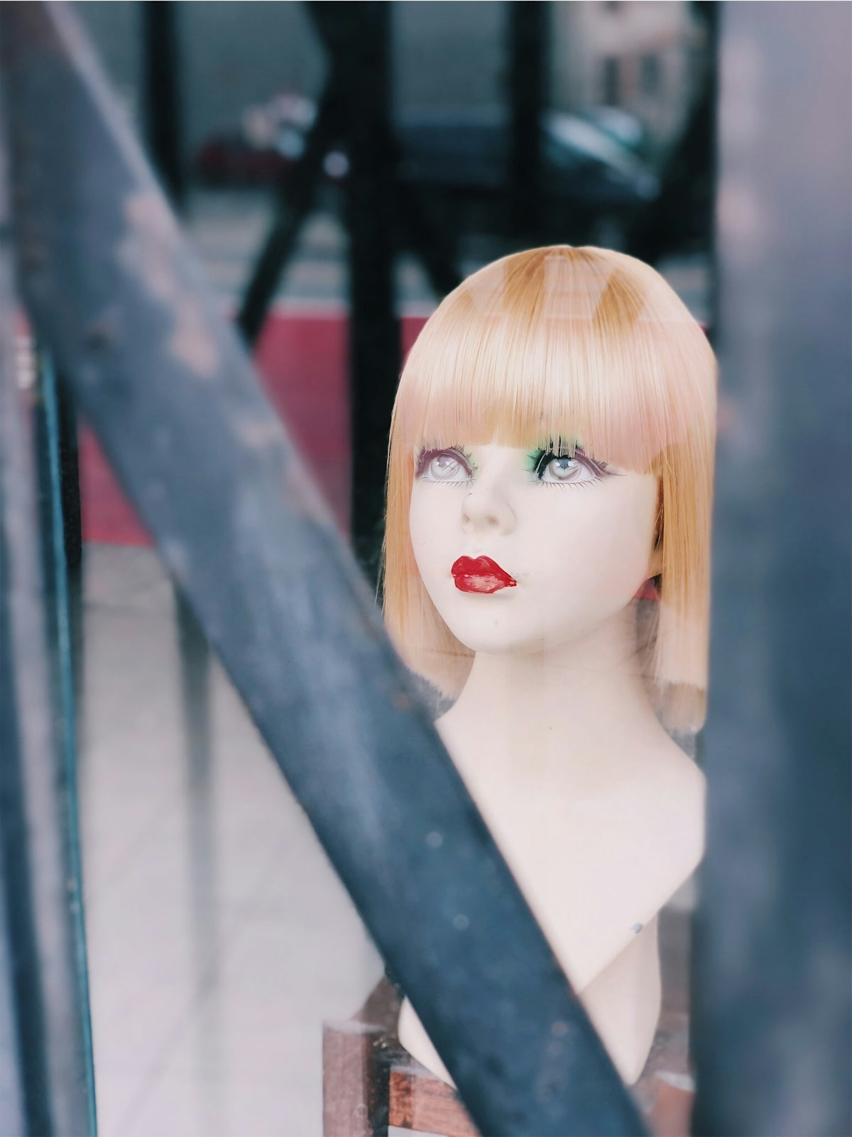 A mannequin head with blonde hair