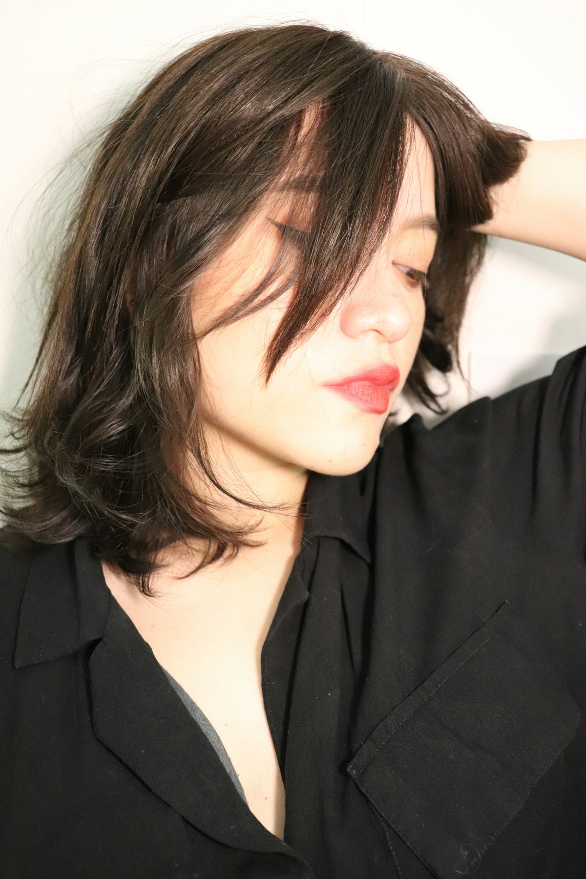 A young woman with brown hair and red lips