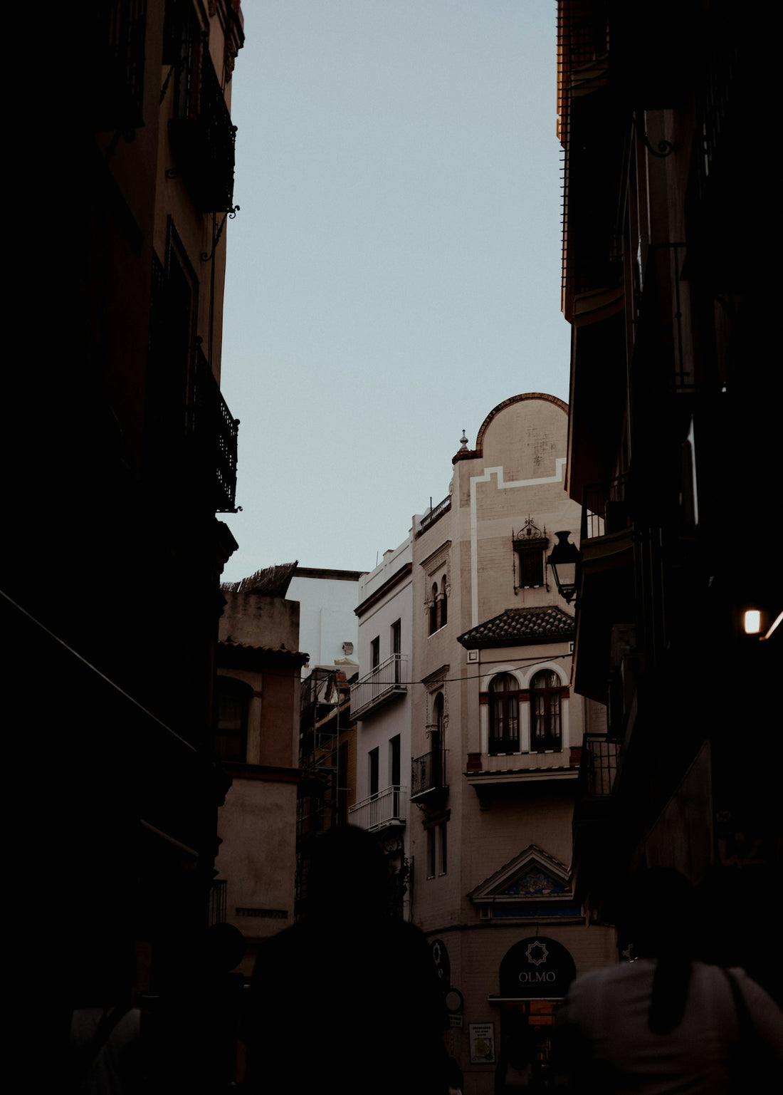 Narrow european street with old buildings and sky