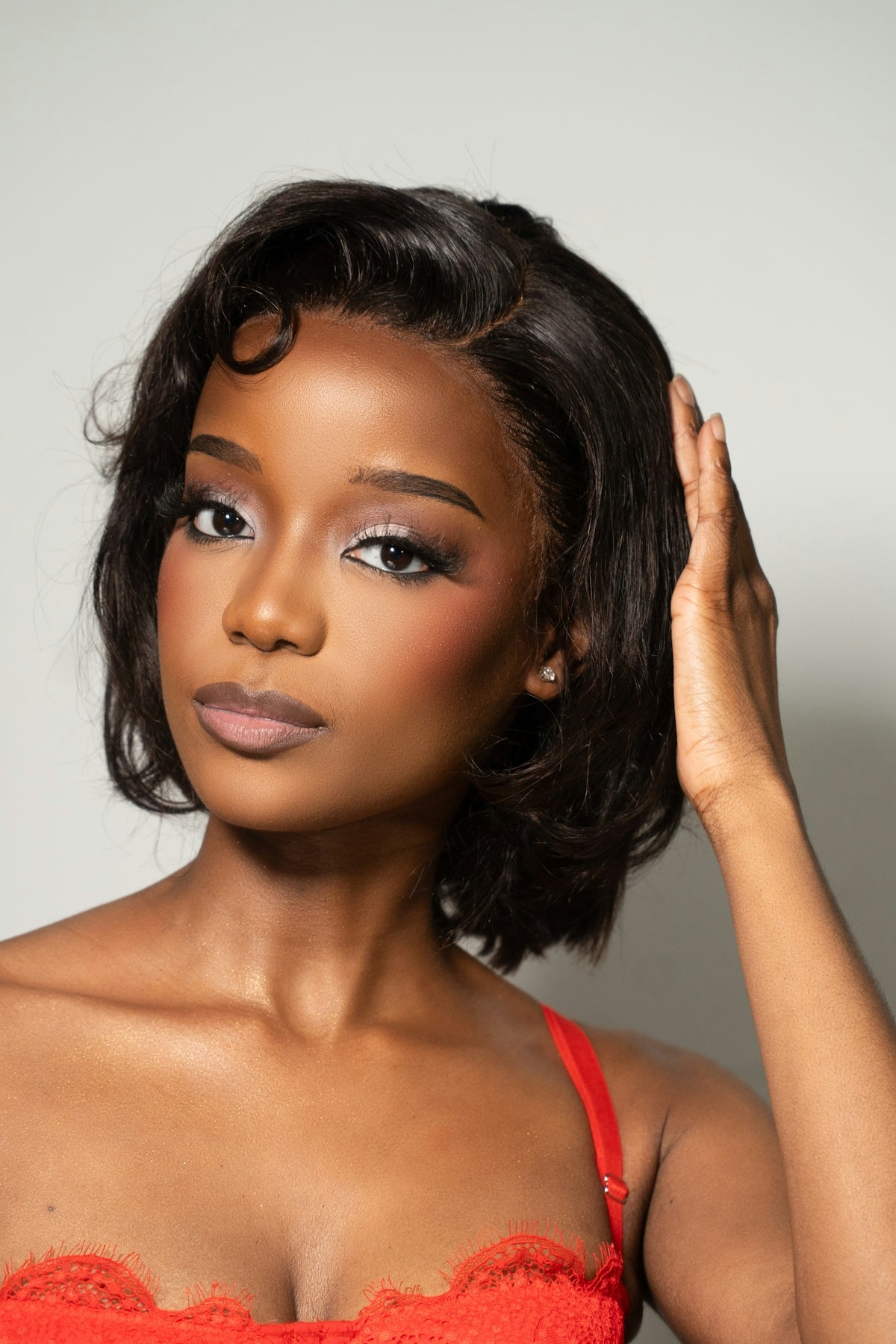 A young woman with dark hair and makeup